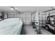 Organized three car garage featuring bicycles, storage, and covering for the car at 1140 Eureka Mill Run, The Villages, FL 32162