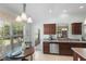 Bright kitchen featuring a breakfast nook with large windows and dark wood cabinetry at 1140 Eureka Mill Run, The Villages, FL 32162