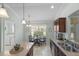Kitchen featuring breakfast nook with backyard view and tile flooring at 1140 Eureka Mill Run, The Villages, FL 32162