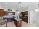 Kitchen featuring an island, stainless steel appliances, and dark wood cabinetry at 1140 Eureka Mill Run, The Villages, FL 32162