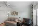 Living room featuring a sofa, a side table with lamp, an armchair and white closet doors at 1140 Eureka Mill Run, The Villages, FL 32162