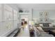 Bright living room with neutral tones, decorative shelves, and seamless bedroom access at 1140 Eureka Mill Run, The Villages, FL 32162