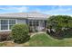 Outdoor patio with stylish furniture, lush landscaping, and a well-maintained yard at 1140 Eureka Mill Run, The Villages, FL 32162