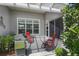 Covered patio with red lounge chairs and a grill at 1140 Eureka Mill Run, The Villages, FL 32162
