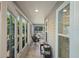 Enclosed sunroom featuring tile floors and an exterior view at 1140 Eureka Mill Run, The Villages, FL 32162