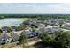 An aerial view captures the layout of a new neighborhood with pond views and a treed horizon at 1268 Patterson Ter, Lake Mary, FL 32746