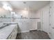 Bathroom featuring double sinks, granite countertops, and a tiled shower with a built-in seat at 1268 Patterson Ter, Lake Mary, FL 32746