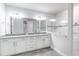 Bright bathroom with double sinks, granite countertop, and a glass-enclosed shower at 1268 Patterson Ter, Lake Mary, FL 32746