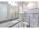Bathroom boasts granite counters, a sink, and a shower with sliding glass doors and decorative tile at 1268 Patterson Ter, Lake Mary, FL 32746