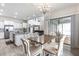Open-concept dining area featuring a chandelier and sliding glass doors to the outdoor patio at 1268 Patterson Ter, Lake Mary, FL 32746