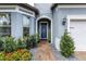 Charming home entrance with a brick path, beautiful landscaping, and a welcoming blue front door at 1268 Patterson Ter, Lake Mary, FL 32746