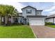 Charming two-story home with a brick driveway, lush landscaping, and inviting curb appeal at 1268 Patterson Ter, Lake Mary, FL 32746