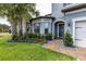 Home featuring vibrant landscaping, a brick walkway, and a charming entrance with a wreath on the front door at 1268 Patterson Ter, Lake Mary, FL 32746