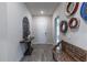 Inviting hallway featuring decorative wall art, a stylish bench, and wood-look flooring at 1268 Patterson Ter, Lake Mary, FL 32746