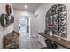 Inviting hallway featuring decorative wall art, a stylish bench, and wood-look flooring at 1268 Patterson Ter, Lake Mary, FL 32746
