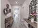 Hallway featuring grey floors, wall decor and bench with access to other rooms in the home at 1268 Patterson Ter, Lake Mary, FL 32746