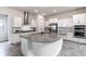 Bright kitchen features white cabinets, stainless steel appliances, and a large island with granite countertops at 1268 Patterson Ter, Lake Mary, FL 32746