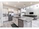 Gourmet kitchen with a large island, stainless appliances, white cabinetry, and open to the living area at 1268 Patterson Ter, Lake Mary, FL 32746