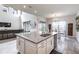 Kitchen island with granite countertops, double sinks, and stainless steel dishwasher, adjacent to dining area at 1268 Patterson Ter, Lake Mary, FL 32746