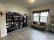 Cozy living room with beautiful hardwood floors, large bookshelf, and window bench at 1268 Patterson Ter, Lake Mary, FL 32746