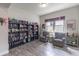 A cozy living room with a bookshelf, two armchairs, and a window providing natural light at 1268 Patterson Ter, Lake Mary, FL 32746