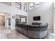 The expansive living room features high ceilings, a large sectional sofa and access to other rooms at 1268 Patterson Ter, Lake Mary, FL 32746