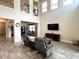 Open concept living room with high ceilings and balcony views, providing great natural light at 1268 Patterson Ter, Lake Mary, FL 32746