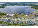 An aerial view of waterfront houses by a large lake in a suburban neighborhood at 13304 Magnolia Valley Dr, Clermont, FL 34711