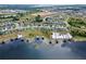 An aerial view of houses with docks on a lake, providing direct access to waterfront activities at 13304 Magnolia Valley Dr, Clermont, FL 34711