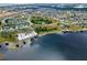 An aerial view of suburban homes on a lake with docks at 13304 Magnolia Valley Dr, Clermont, FL 34711