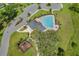 Aerial view of a community pool, playground area, and walking trail with convenient parking at 13304 Magnolia Valley Dr, Clermont, FL 34711