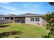 Backyard view showcasing the screened-in patio and well-kept lawn surrounded by a privacy fence at 13304 Magnolia Valley Dr, Clermont, FL 34711