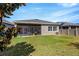 Lush backyard featuring a screened lanai, verdant grass, and privacy fencing at 13304 Magnolia Valley Dr, Clermont, FL 34711