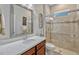 Bathroom featuring a glass enclosed shower and a vanity with a light marble countertop at 13304 Magnolia Valley Dr, Clermont, FL 34711