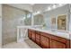 Bathroom featuring double sinks, stone countertops, and a large walk-in shower at 13304 Magnolia Valley Dr, Clermont, FL 34711