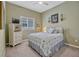 Bedroom with soft green walls, a patterned bedspread and a ceiling fan provides comfort at 13304 Magnolia Valley Dr, Clermont, FL 34711
