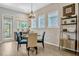 Bright breakfast nook features a modern light fixture, wine cooler and views of the backyard at 13304 Magnolia Valley Dr, Clermont, FL 34711