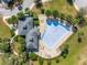 Aerial view of community pool and amenity center with lounge chairs at 13304 Magnolia Valley Dr, Clermont, FL 34711