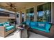 Cozy covered patio with wicker furniture and a ceiling fan, perfect for relaxing outdoors at 13304 Magnolia Valley Dr, Clermont, FL 34711