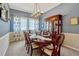 Formal dining room with classic hutch, table for eight, and elegant window treatments at 13304 Magnolia Valley Dr, Clermont, FL 34711