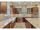 Spacious kitchen featuring stainless steel appliances, stone countertops, and custom cabinets at 13304 Magnolia Valley Dr, Clermont, FL 34711