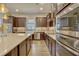 Bright kitchen with stainless steel appliances, center island and modern fixtures at 13304 Magnolia Valley Dr, Clermont, FL 34711