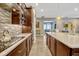 Modern kitchen boasts a spacious island, sleek appliances, stone countertops, and stylish backsplash at 13304 Magnolia Valley Dr, Clermont, FL 34711