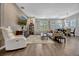Bright living area with contemporary furnishings, wood floors, and scenic views at 13304 Magnolia Valley Dr, Clermont, FL 34711