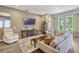 Cozy living room with modern furnishings, plush seating, and lots of natural light at 13304 Magnolia Valley Dr, Clermont, FL 34711