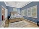 Comfortable main bedroom offers bright windows, neutral decor, and serene atmosphere at 13304 Magnolia Valley Dr, Clermont, FL 34711