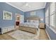 Relaxing main bedroom with plush bedding, ample natural light, and ensuite bathroom access at 13304 Magnolia Valley Dr, Clermont, FL 34711