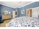 Spacious main bedroom featuring soothing blue walls, stylish dresser, and neutral-toned decor at 13304 Magnolia Valley Dr, Clermont, FL 34711