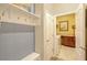 View of mud room leading into laundry room with overhead rack with hooks and a built-in bench at 13304 Magnolia Valley Dr, Clermont, FL 34711