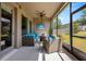 Relaxing screened patio with comfortable seating and a ceiling fan overlooking the backyard at 13304 Magnolia Valley Dr, Clermont, FL 34711